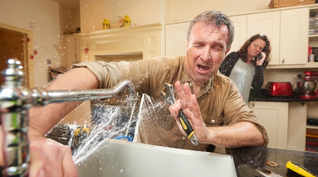 Professional plumber diagnosing a suspected broken pipe beneath a sink, comparing signs of pipe damage with other common plumbing issues.